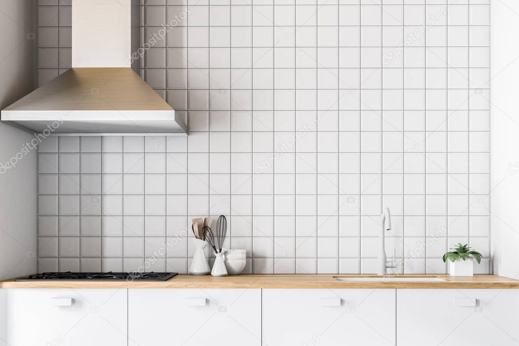 White countertops in modern tiled kitchen closeup