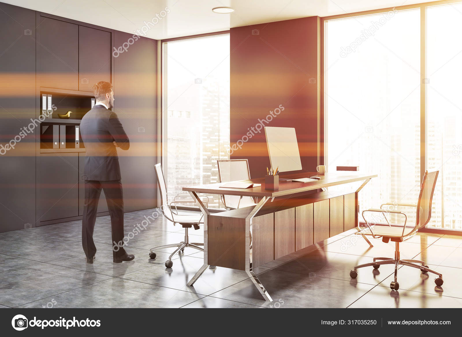 Businessman In Gray Ceo Office Stock Photo
