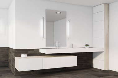 Lavabosu olan beyaz ve gri banyo köşesi.