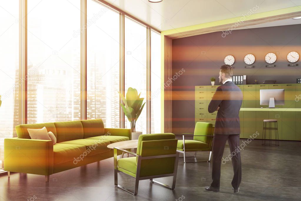 Businessman in gray office lounge area
