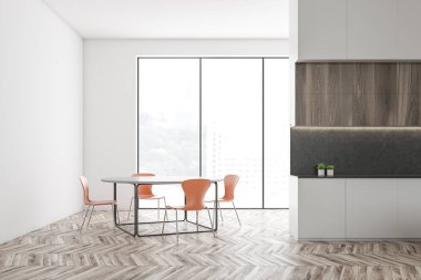 Tezgahı ve masası olan beyaz mutfak.