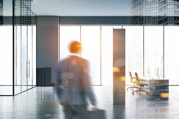 Man entering gray open space office — Stock Photo, Image