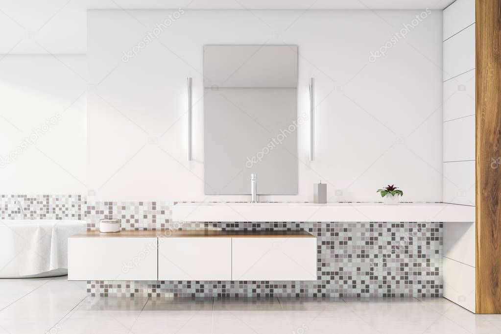 Sink and tub in white and mosaic bathroom