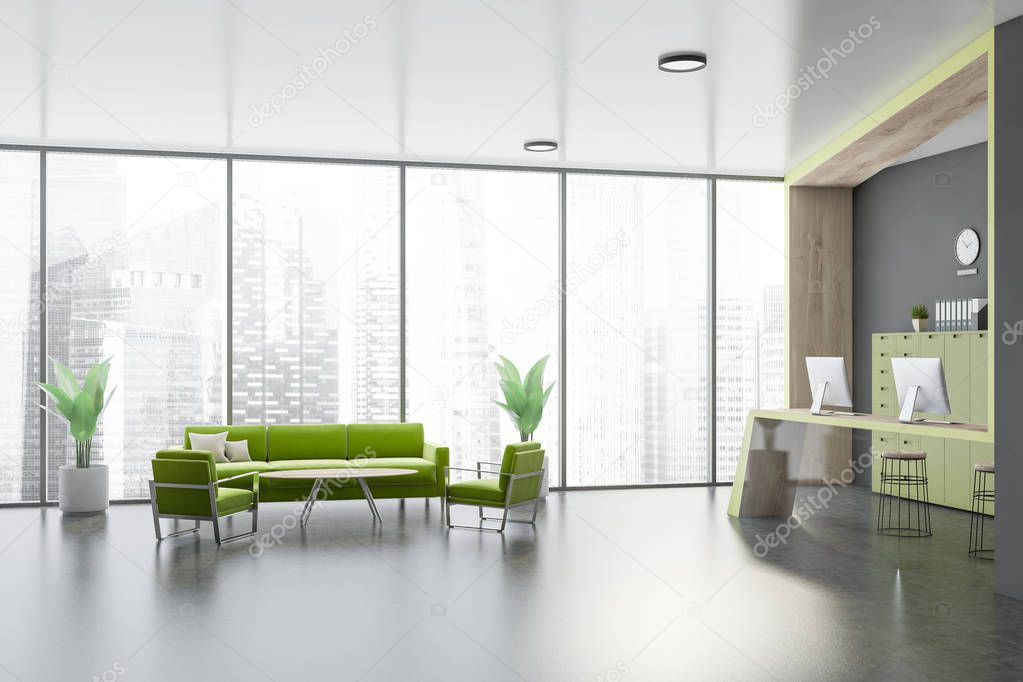 Gray office waiting room with green sofa
