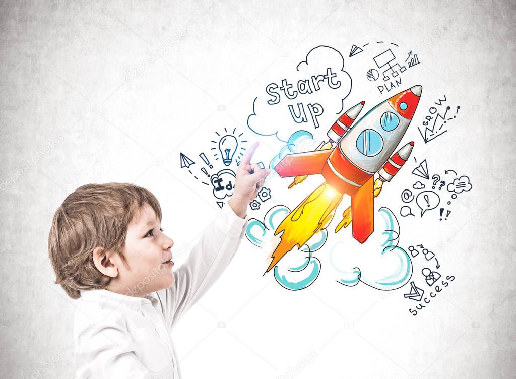 Little boy pointing at startup sketch