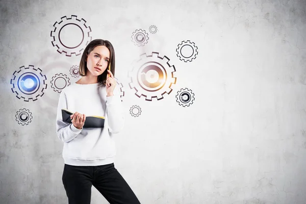 Woman with notebook and gears sketch