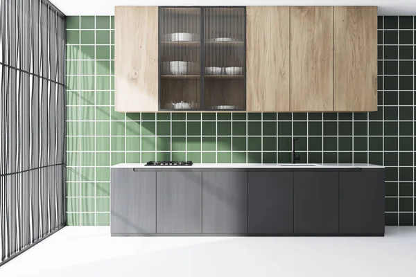 Green tile kitchen interior with gray countertops
