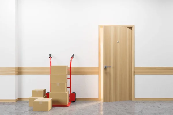 Stack of boxes and hand truck near door. Delivery — Stock Photo, Image