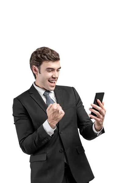 Happy businessman with phone celebrating, isolated — ストック写真