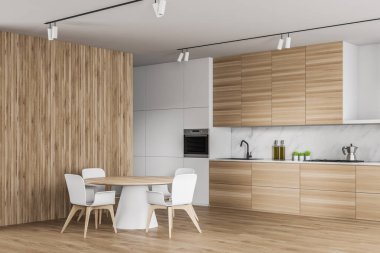 Yuvarlak masalı beyaz ve ahşap mutfak köşesi