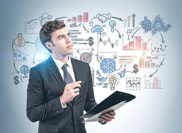 Businessman with clipboard and his business plan — Stock Photo, Image