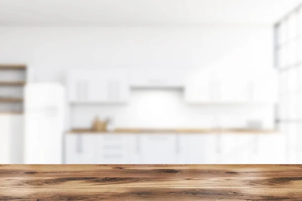 Table in blurry white kitchen with fridge — Stock Photo, Image