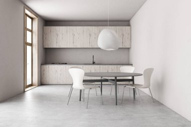 Yuvarlak yemek masası olan geniş beyaz mutfak.