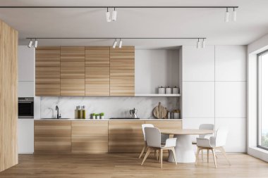 Tezgahı ve barı olan beyaz ve ahşap mutfak.