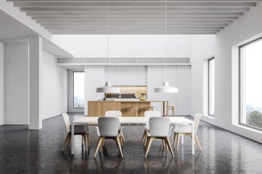 Bar ve yemek masası olan geniş beyaz mutfak.