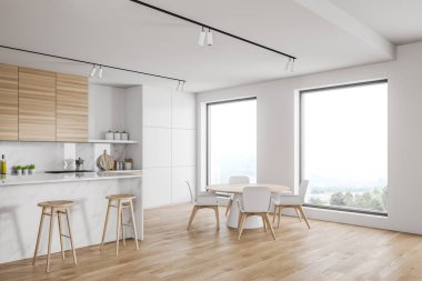 Çatı katı beyaz mutfak, bar ve masa.