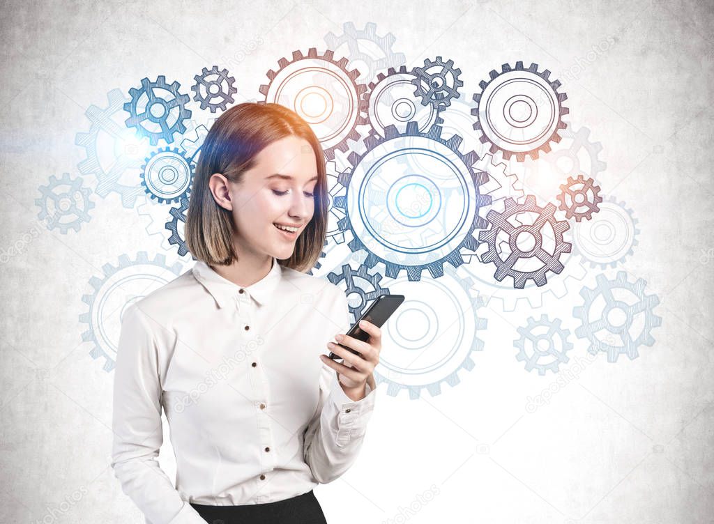 Businesswoman with smartphone, gears and cogs