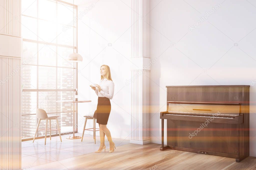 Woman in white cafe with piano