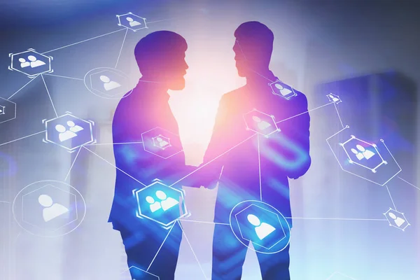 Partners shaking hands in city, social network