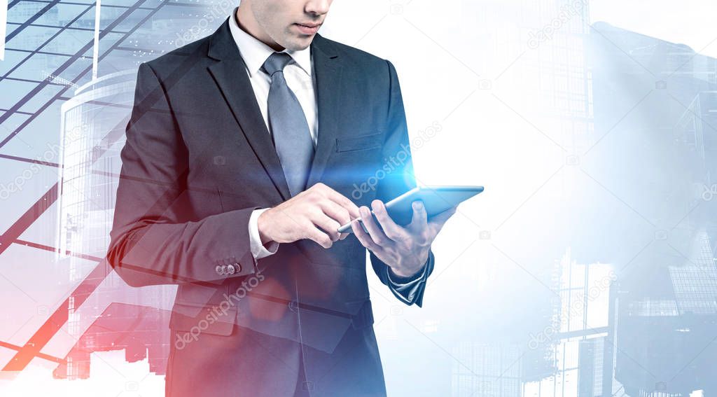Unrecognizable businessman using tablet in city