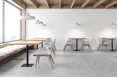 Beyaz ve ahşap bir kafe. İçi banklarla dolu.