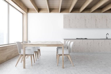 İçi tezgah ve masa dolu beyaz mutfak.