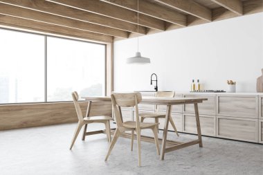 Beyaz mutfak köşesi, tezgah ve ahşap masa.