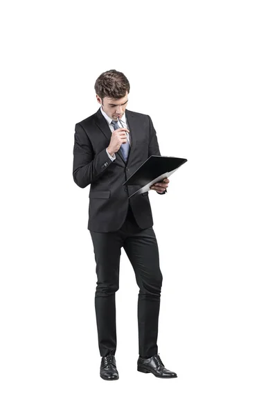 Thoughtful businessman with clipboard, full length — 스톡 사진