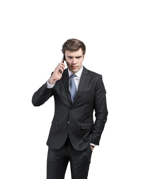 Frowning young businessman on phone — 스톡 사진