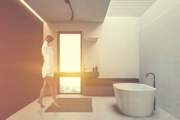 Woman walking in white and gray loft bathroom — 스톡 사진