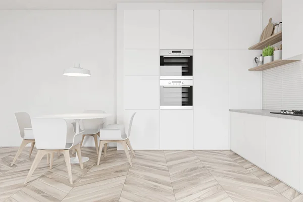 White kitchen with ovens and round table side view — 스톡 사진
