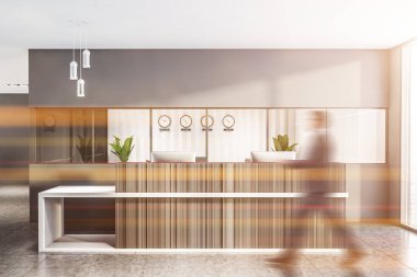 Gri ofis resepsiyonundan geçen bir iş adamı