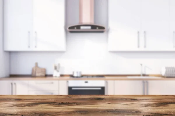 Table in blurry white kitchen with countertops — Stock Photo, Image