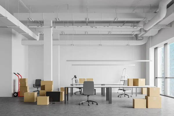 Boxes in open space office, moving concept