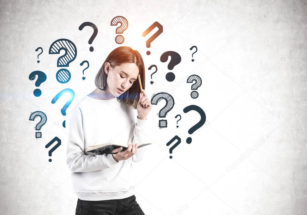 Woman with notebook and question marks