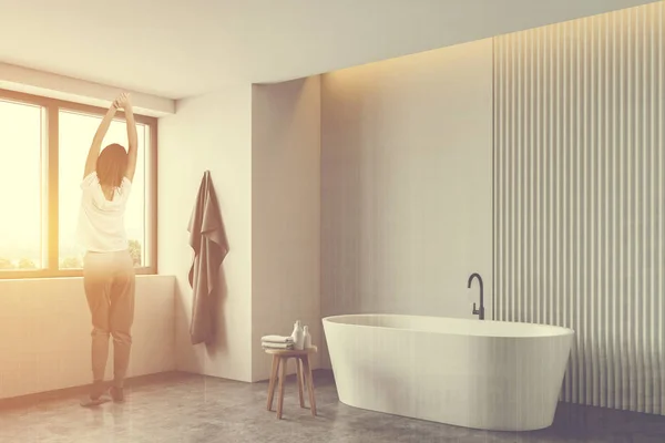 Woman in white stylish bathroom with tub — 스톡 사진