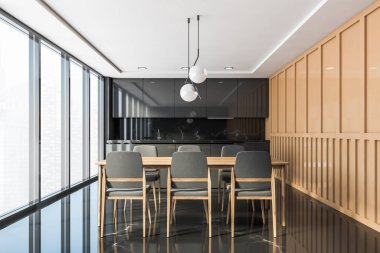 Siyah ve bej mutfak, tezgah ve masa.