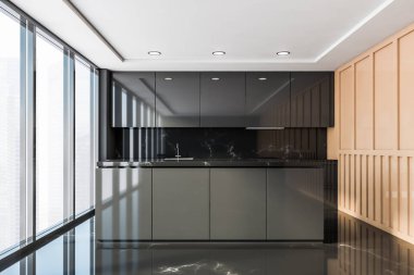 Tezgahı olan siyah ve bej mutfak.