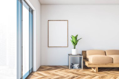 Kanepesi ve posteri olan beyaz bir oturma odası.