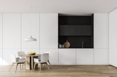 Tezgahı ve masası olan siyah ve beyaz mutfak.