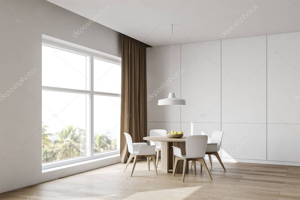 White dining room corner with round table