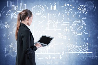Woman with laptop looking at business plan
