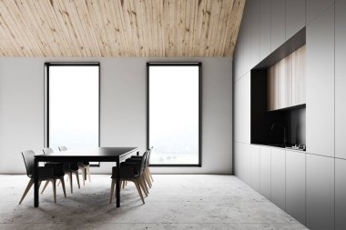 Yemek masası olan gri ve beyaz tavan arası mutfağı.