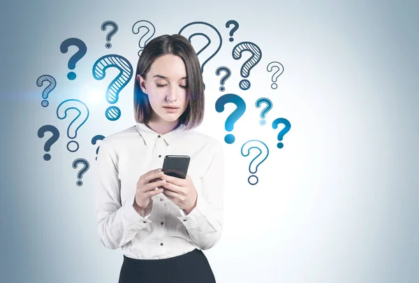 Woman with smartphone and question marks — Stock Photo, Image