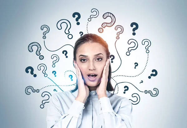 Astonished young woman with many questions — Stock Photo, Image