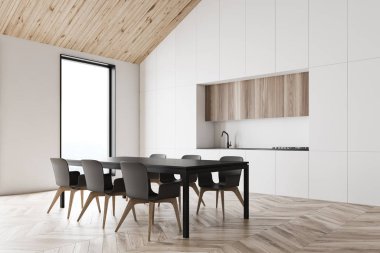 Beyaz tavan arası mutfak köşesi ve yemek masası.