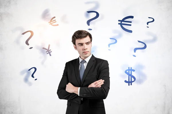 Young businessman and currency choice — Stock Photo, Image