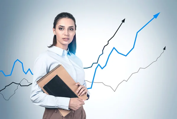 Businesswoman with notebooks, growing graphs — Stock Photo, Image