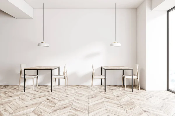 Square wooden tables with white chairs standing in spacious minimalistic cafe interior with white walls and wooden floor. 3d rendering