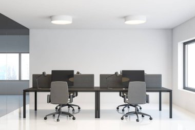 Beyaz duvarları, beton zemini ve üzerinde yuvarlak lambalar olan iki gri bilgisayar masası olan modern açık uzay ofisindeki işyeri. 3d oluşturma